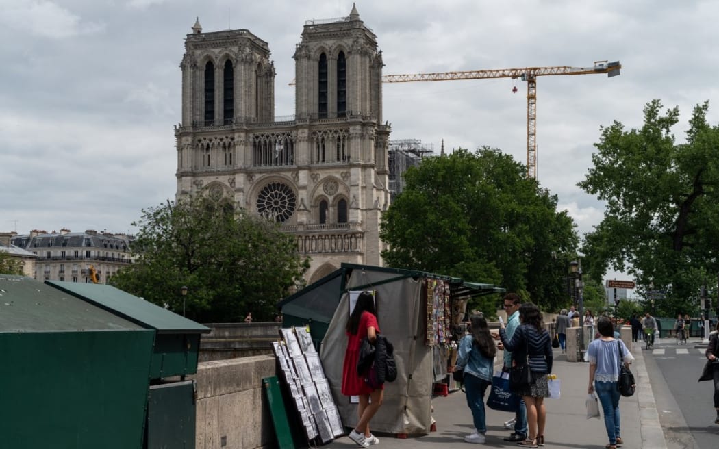 Resumption of work at Notre-Dame de Paris after confinement. Paris, June 14 2020. The repair work had to be stopped because of the coronavirus outbreak.?La reprise des travaux a Notre-Dame de Paris apres le confinement. Paris, 14 juin 2020. Demontage de l'echafaudage de la cathedrale de Notre Dame. Le travail de refection avait du etre arrete en raison de la crise du coronavirus. Bouquinistes. Photography by Riccardo Milani / Hans Lucas (Photo by Riccardo Milani / Hans Lucas / Hans Lucas via AFP)