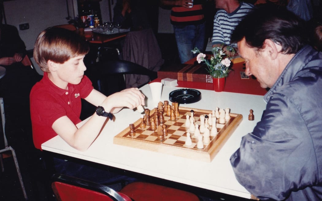 This handout photograph released by Kensington Palace on October 25, 2024, shows 11-year-old William (L), now Britain's Prince William, Prince of Wales playing a game of chess during one of his first visits to homelessness charity, The Passage in London, taken on 14 June, 1993.