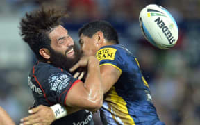 The Warriors' Konrad Hurrell loses the ball as the Cowboy's Jason Taumalolo makes a tackle.