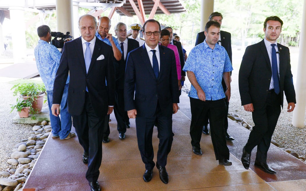 The French President, Francois Hollande, centre, and Foreign Minister, Laurent Fabius, left, arrive at the Secretariat for the Pacific Community in Noumea