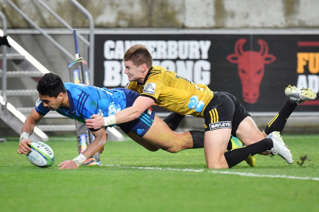Rieko Ioane dives over to score in the tackle of Jordie Barrett