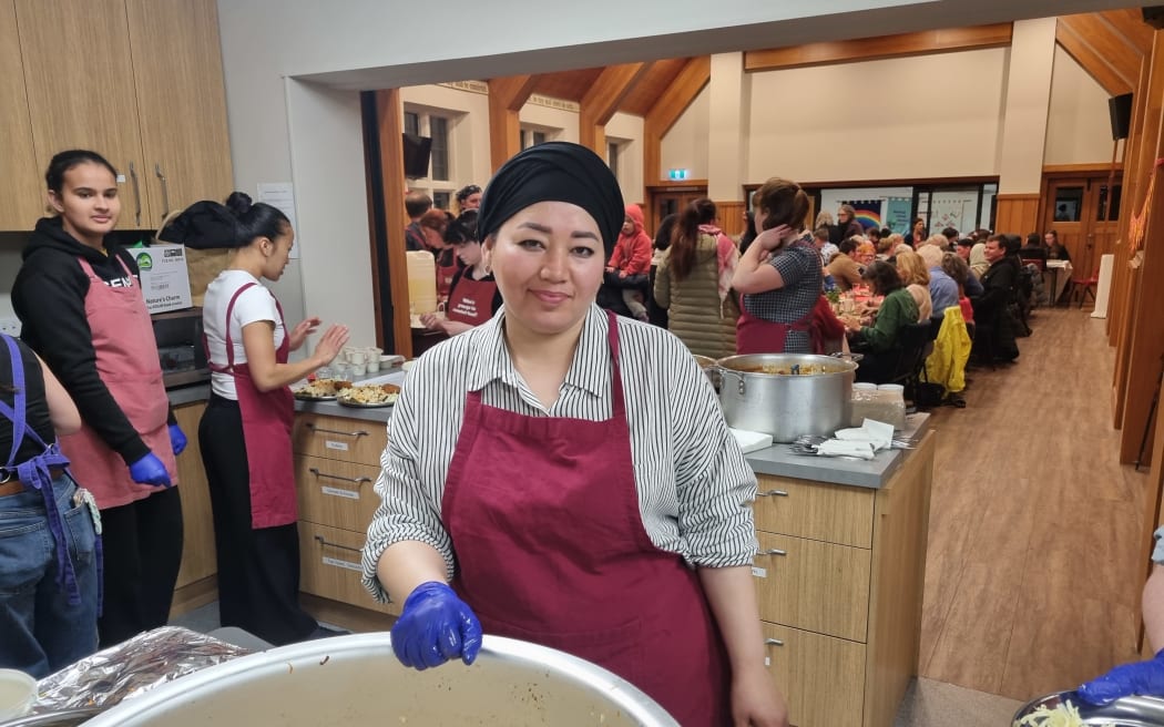 Jamila Ehsani in front of a large pot of rice at a Share kai event in Christchurch.