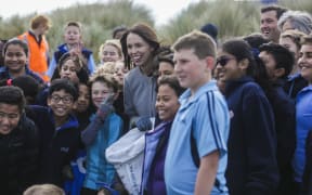 Prime Minister Jacinda Ardern and children from Petone College picking up rubbish on Wellington's Lyall Bay beach this morning.