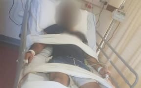 The refugee restrained in a Port Moresby hospital.