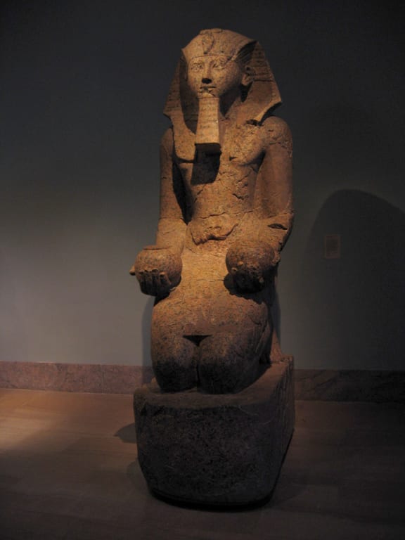 Colossal kneeling statue of Hatshepsut, Eighteenth dynasty of Egypt, c. 1503-1482 B.C.  After Thutmosis III ordered Hatshepsut removed from history, the statue's eyes were gouged out, the uraeus serpent broken from her headdress, and the entire statue finally smashed to pieces.