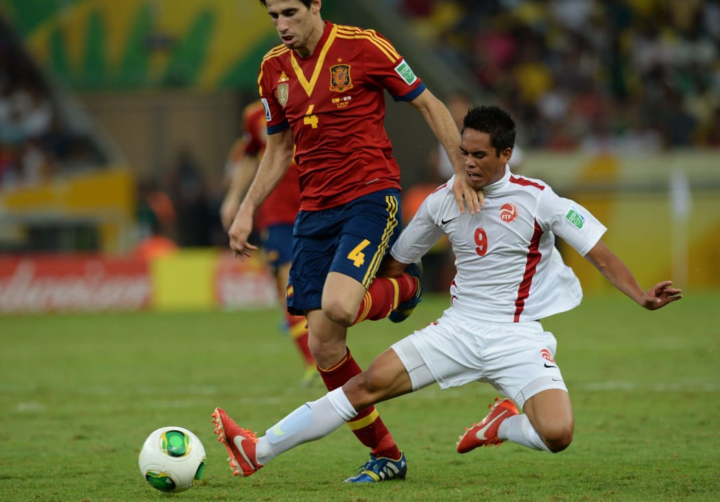 Tahiti's Teaonui Tehau looks to dispossess Spain midfielder Javier Martinez during the 2013 FIFA Confederations Cup in Brazil.