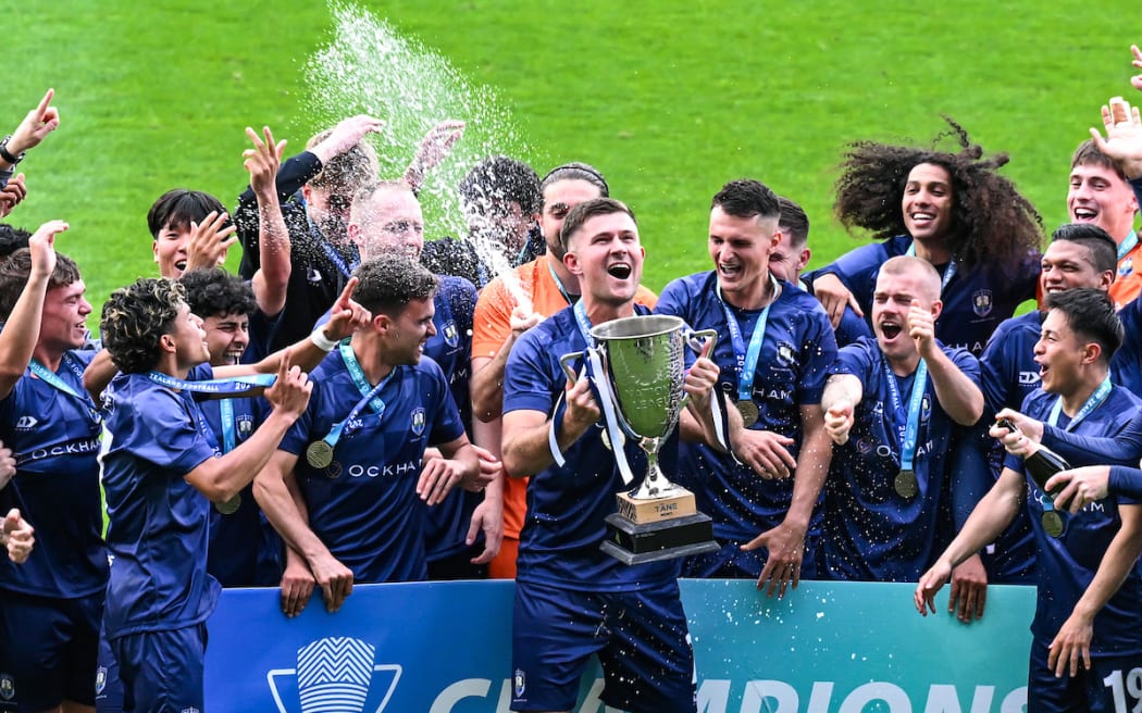 Auckland City FC captain Mario Ilich celebrates with trophy and team.
Birkenhead United FC v Auckland City FC, Men’s National League Football final at North Harbour Stadium, Auckland.