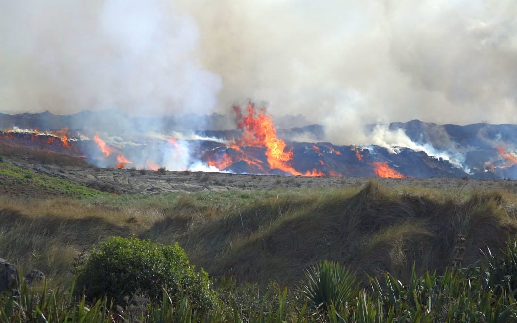 A fire in a 20-metre high pile of woodchips in Christchurch is proving difficult to extinguish.