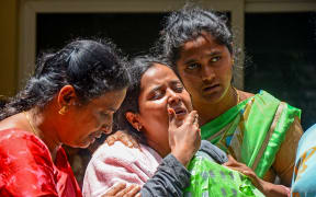 Family members of a victim who died during the stampede outside the M. Chinnaswamy Stadium grieve. Hundreds of thousands had packed the streets in Bengaluru to celebrate Royal Challengers Bengaluru's IPL win, 2025.