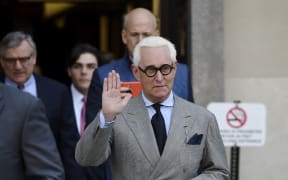 Roger Stone in  March 14, 2019 waves as he leaves a court hearing in Washington DC.