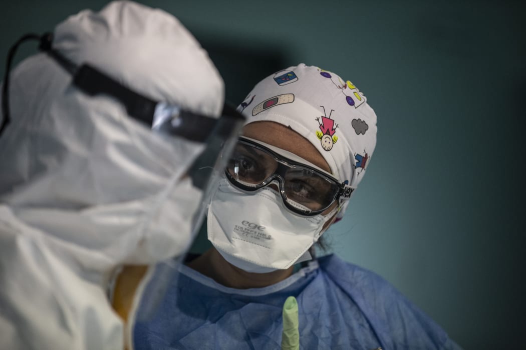 Doctors with protective glasses, protective suits and masks before applying a treatment for a coronavirus patient at Istanbul University Medical Faculty Hospital in Istanbul, Turkey