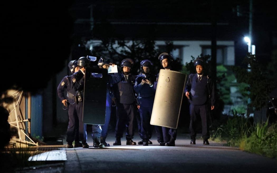 Armed police officers prepare to storm near the house where a suspect has barricaded himself with a hunting gun in Nakano City, Nagano Prefecture on May 26, 2023. According to the local police office, two police officers and one female were confirmed killed. The man killed two male police officers by firing what appeared to be a hunting rifle and a woman by an edged tool and holed himself up inside a building on the previous day. The police officers secured the man when he came outside by himself a little after 4:30 a.m. on the same day, and transported him to the Nakano Police Station.( The Yomiuri Shimbun ) (Photo by Hiroto Sekiguchi / Yomiuri / The Yomiuri Shimbun via AFP)