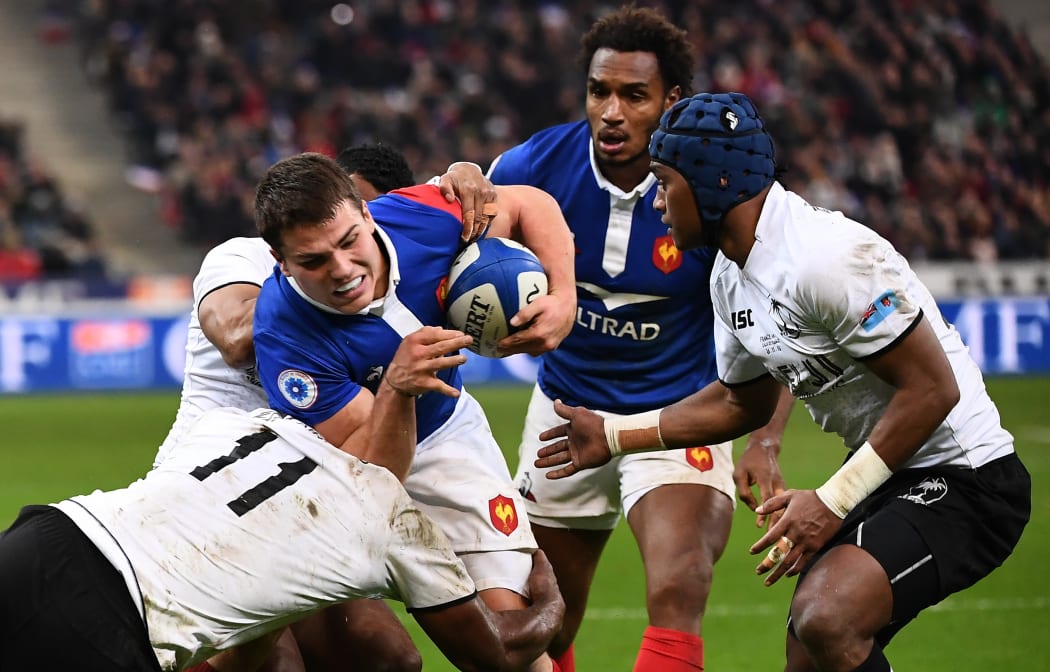 France halfback Antoine Dupont is stopped by Fiji wing Vereniki Goneva.