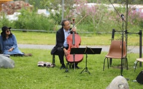 Yo Yo Ma performs a concert on the banks of the Avon river for Christchurch locals