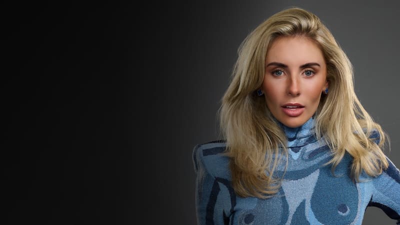 Bonnie Blue is a smooth-skinned white woman with big blonde hair and a blue top.