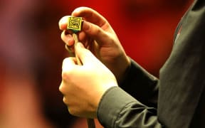 15/01/2012 - BGC Master Snooker - 2012 - Ding Junhui v Ronnie O'Sullivan- Ding Junhui chalks up his cue. - Photo: Charlie Crowhurst / Offside.