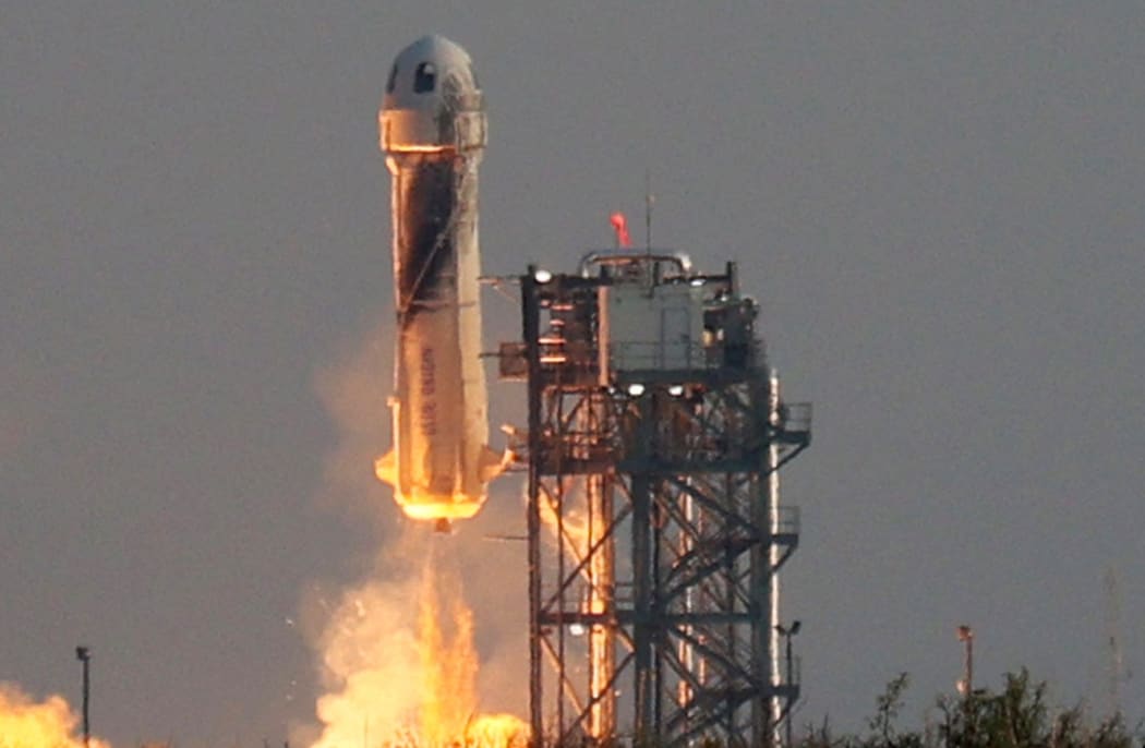VAN HORN, TEXAS - JULY 20: Blue Origins New Shepard lifts-off from the launch pad carrying Jeff Bezos along with his brother Mark Bezos, 18-year-old Oliver Daemen, and 82-year-old Wally Funk on July 20, 2021 in Van Horn, Texas.