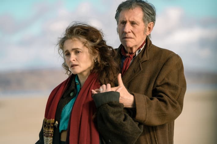 Helena Bonham Carter, as Margaret Gore, in Four Letters of Love, holding the hand of Gabriel Byrne, as Muiris Gore, standing behind her.