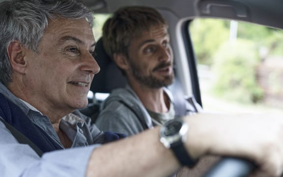 Father and son travelling by car (Photo by Frédéric Cirou / AltoPress / PhotoAlto via AFP)