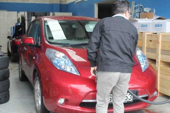 This is an image of Steve West charging up the little Nissan Leaf. Ten dollars for a full tank!