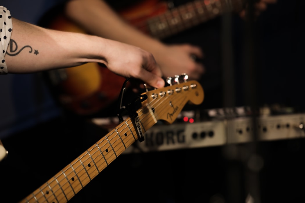 Edward Castelow of Dictaphone Blues tunes his guitar