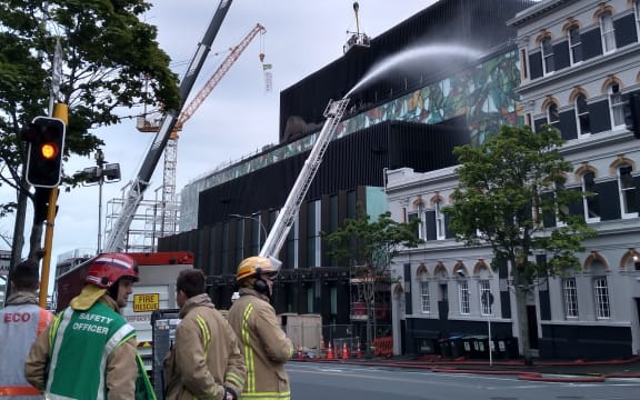 A crane has been brought in to help put out the fire.