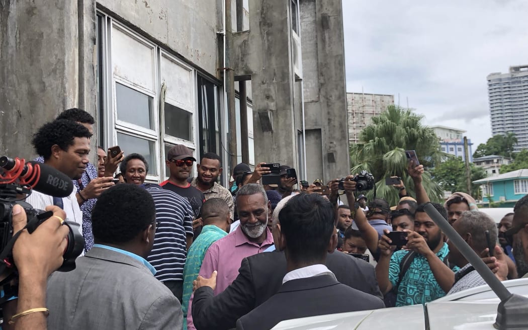 All smiles - Bainimarama surrounded by his supporters after being granted an absolute discharge without conviction.