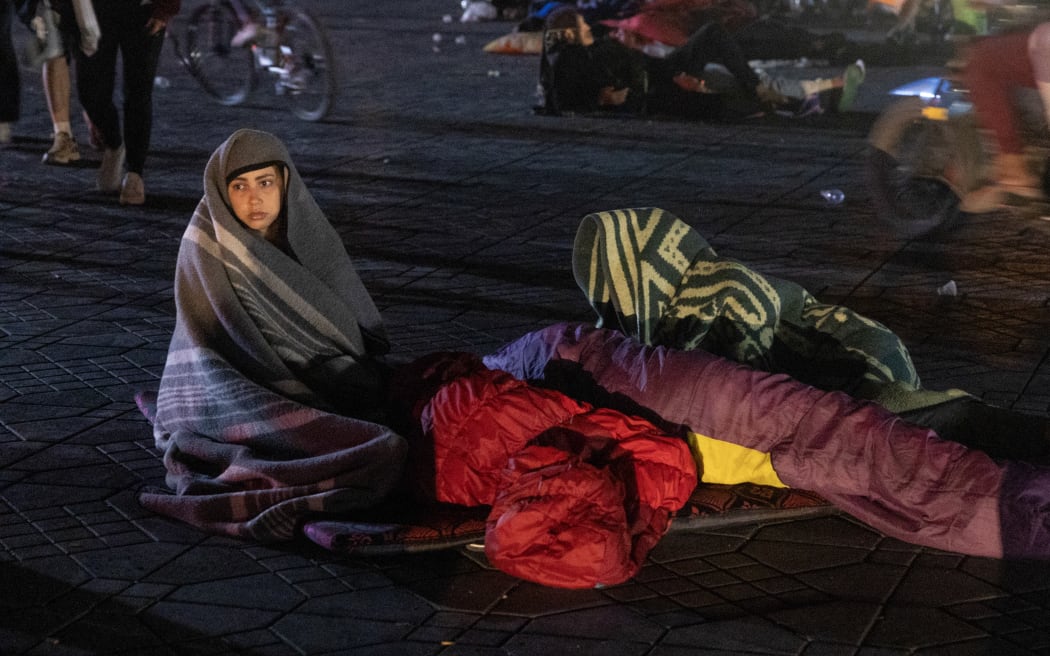 Residents stay out at a square following an earthquake in Marrakesh on September 9, 2023. Nearly 300 people were killed after a powerful earthquake rattled Morocco on September 8 night, according to a preliminary government count, with Marrakesh residents reporting "unbearable" screams followed the 6.8-magnitude quake. (Photo by FADEL SENNA / AFP)