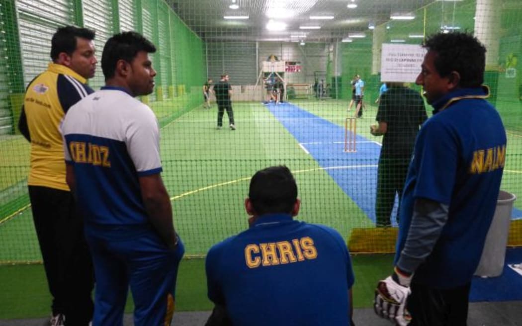 A team of Sri Lankans, including Nal Ariyawansa, watch a game of indoor cricket.