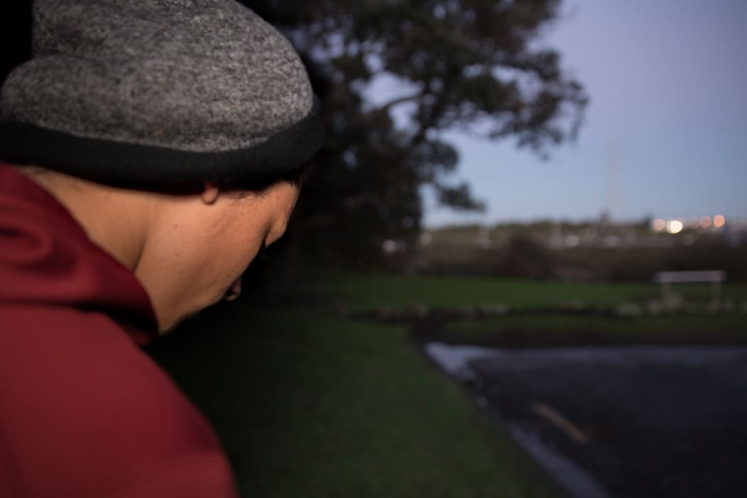 A teenage Māori boy looking unhappy