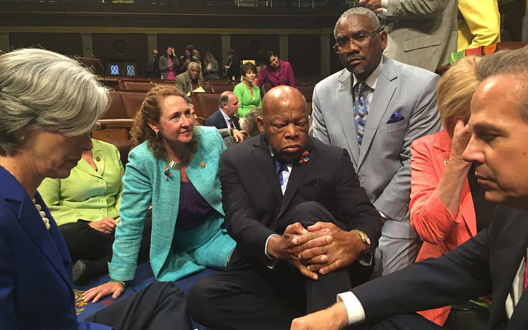 Representative Elizabeth Esty's office sent this picture showing her to the left of John Lewis with his eyes closed staging a sit-in with other members of Congress on the floor of the US House of Representatives.