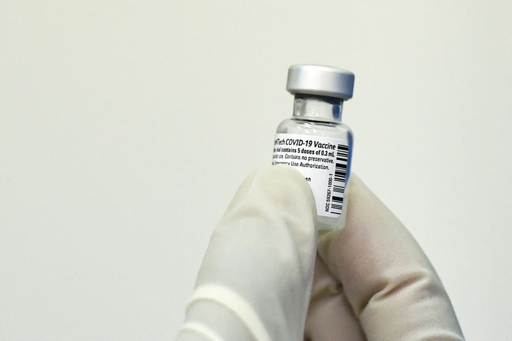 A nurse holds a vial of the Pfizer-BioNTech vaccine against Covid-19.