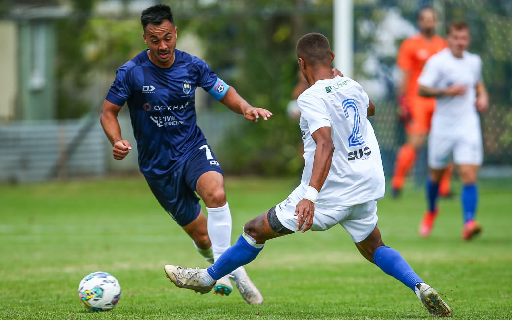 Cam Howieson (L) of Auckland City avoids the attention of Gabiriele Matanisiga of Wellington Olympic during their OFC men's Champions League national playoff.