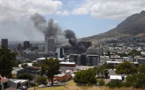 Smoke rises up from the Parliament building in Cape Town.