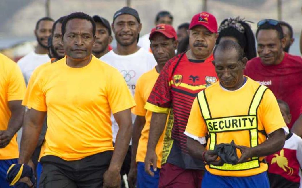 The governor of Papua New Guinea's National Capital District, Powes Parkop on his weekly Sunday walk and yoga sessions (in red cap third from right)