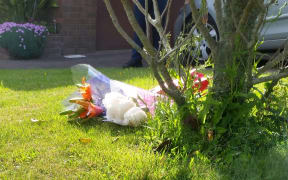 Flowers left at the scene of a death in Churton Park. Police have launched a homocide inquiry.