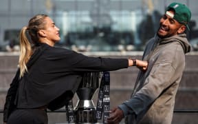 Aryna Sabalenka (L) pushes Australia's Nick Kyrgios during a press conference on the eve of the Battle of the Sexes exhibition match in Dubai.