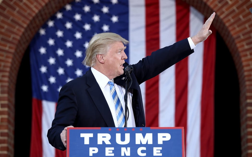 Donald Trump waves to supporters as he campaigns in Virginia, 22 October 2016.