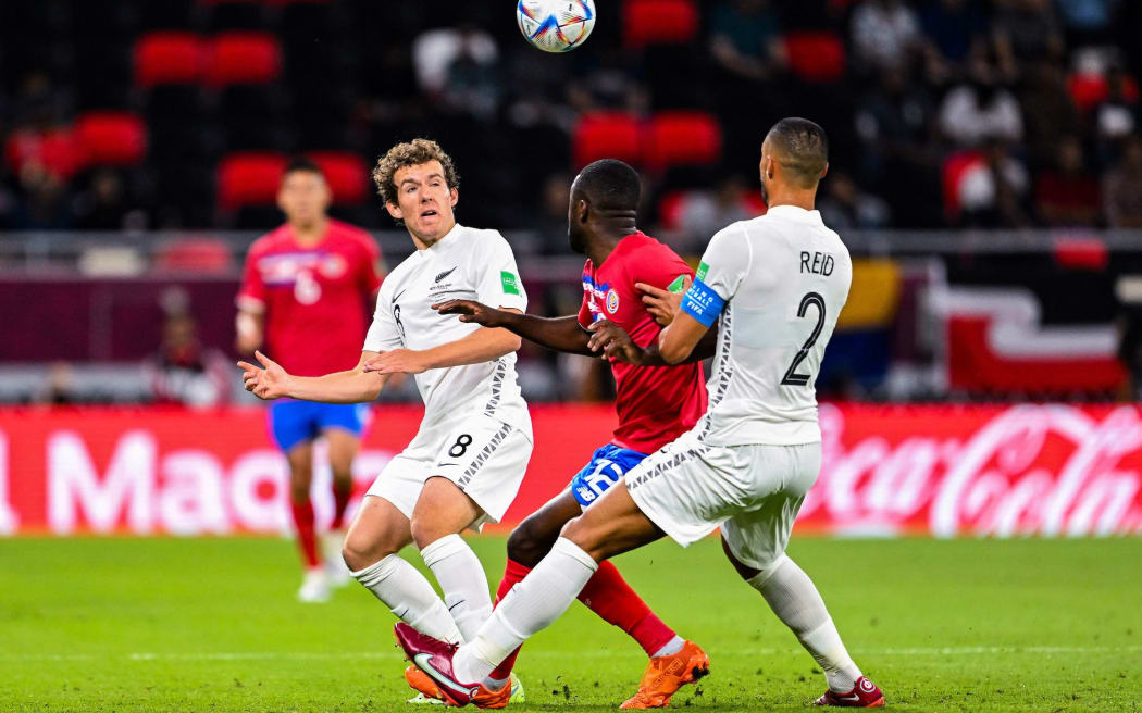 Joe Bell of New Zealand All Whites (l) battles for the ball with Joel Campbell of Costa Rica (c) during New Zealand All Whites v Costa Rica World Cup Intercontinental Playoff Match at Ahmad Bin Ali Stadium, Doha, Qatar on Tuesday 14 June 2022. © Photo: Simon Lloyd Holmes / Power Sport Images / www.photosport.nz