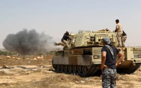 Libyan unity government forces fire from a tank in Sirte towards Ouagadougou.