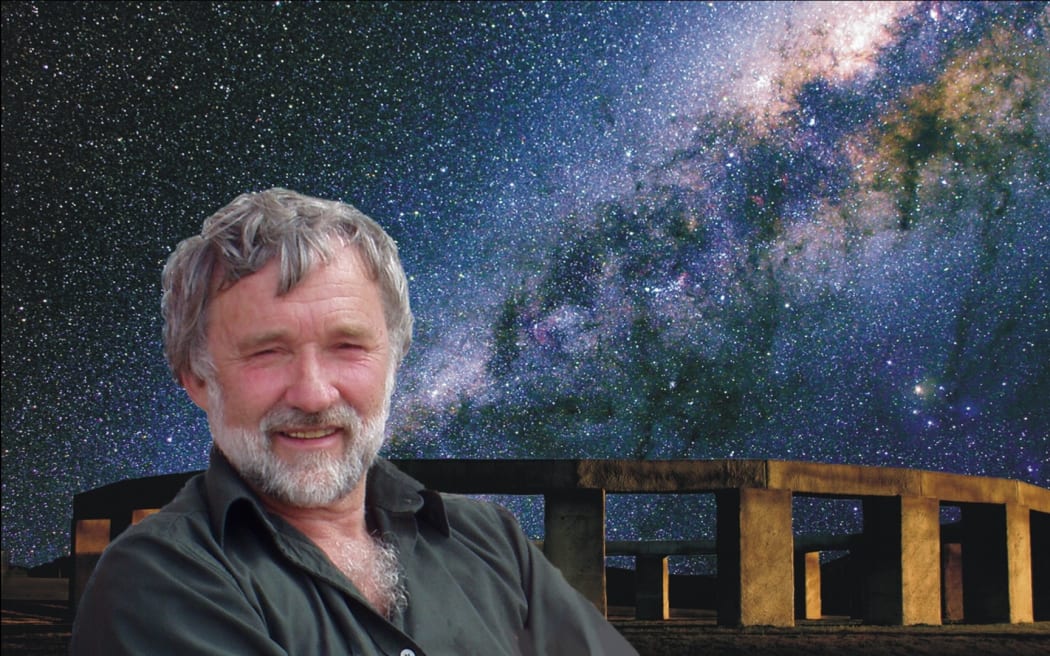 Astronomer Richard Hall stands in front of the replica Stonehenge he built in the Wairarapa with the milky way in the night sky.