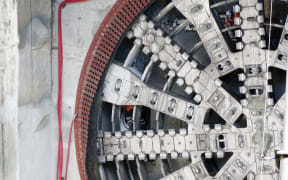Workers inside the tunnel boring machine show its enormous size.
