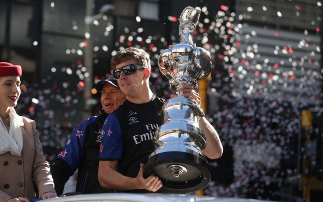 It's Wellington's turn to welcome the America's Cup today, with a parade through the central city. Peter Burling holds the cup.