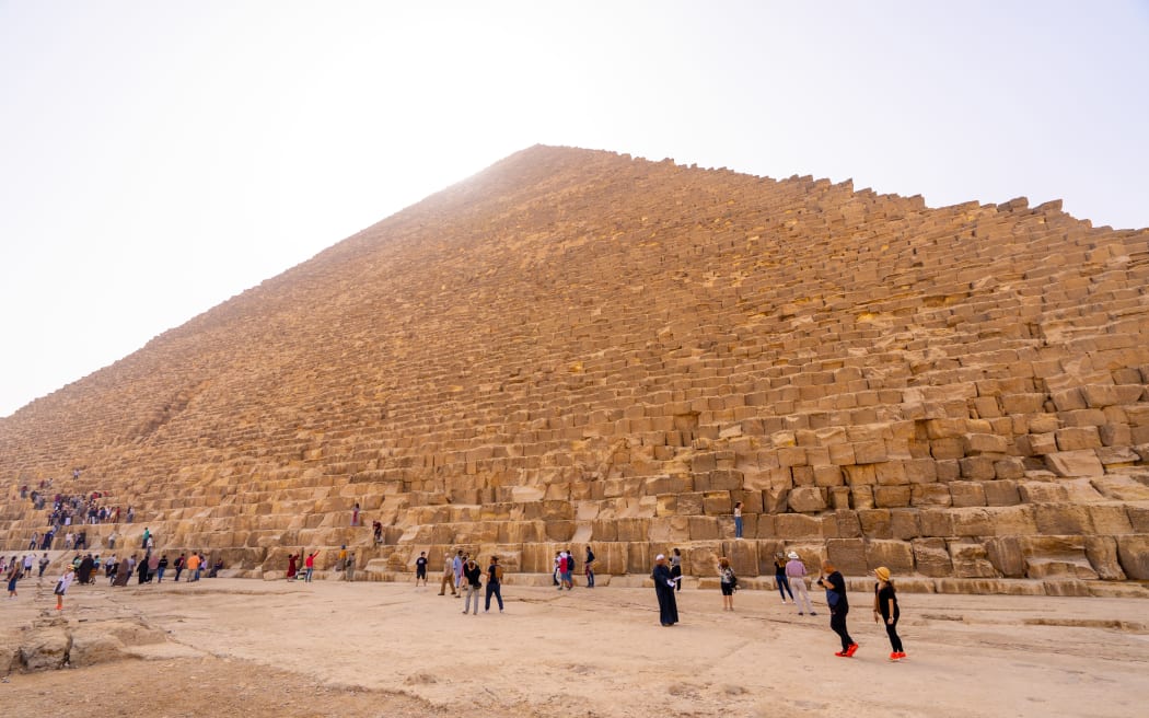 People taking photos and selfies near Pyramids of Giza.