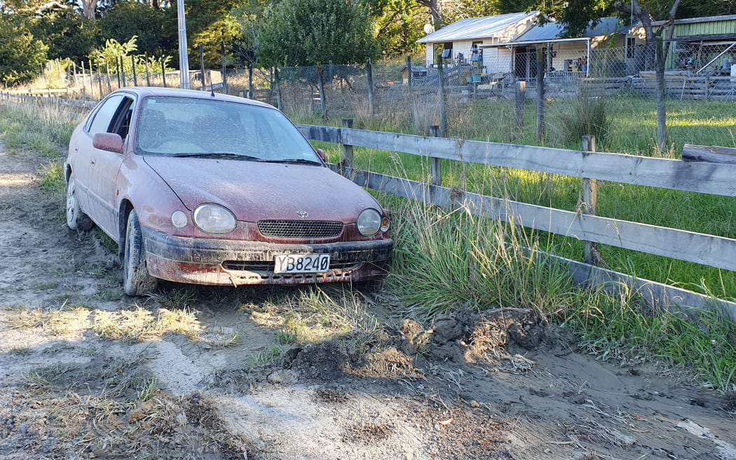 An abandoned mud covered car outside Tīnui shows how high the Whareama River got, near Wairarapa's east coast.