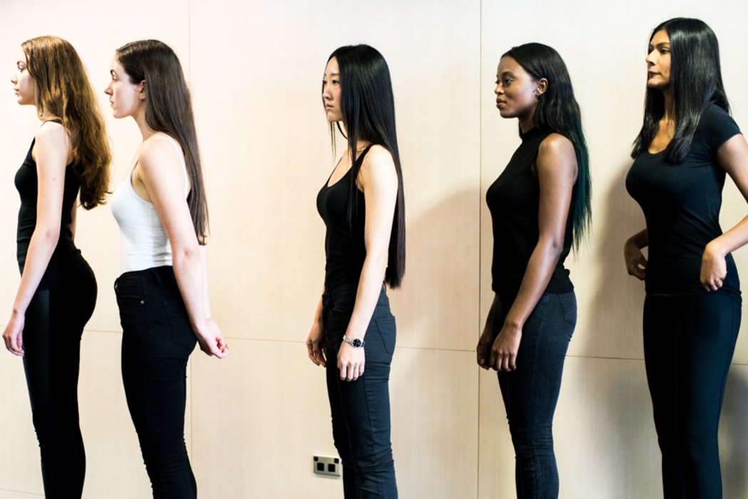 Ethnically diverse Models line up outside the casting room.