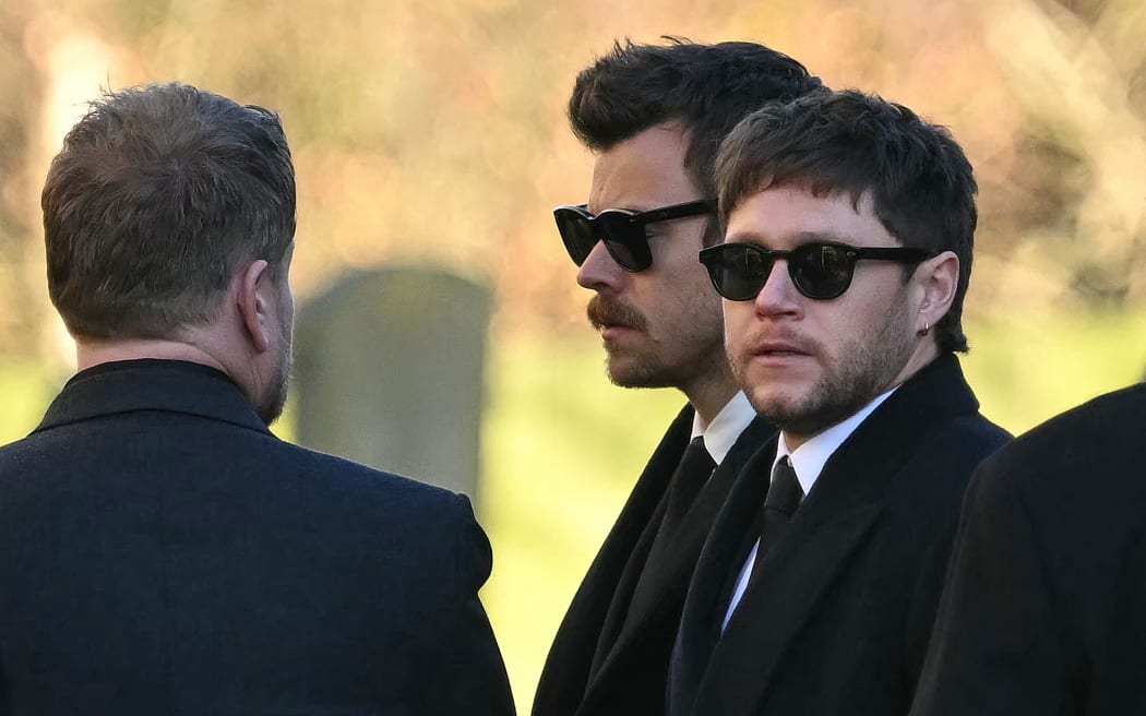 Former One Direction band members Harry Styles (C) and Niall Horan leave after attending the funeral service of the late One Direction singer Liam Payne, at a St Mary's church in Amersham, west of London on November 20, 2024. - The funeral of former One Direction singer Liam Payne who died last month after falling from his Buenos Aires hotel room was held on Wednesday. (Photo by JUSTIN TALLIS / AFP)