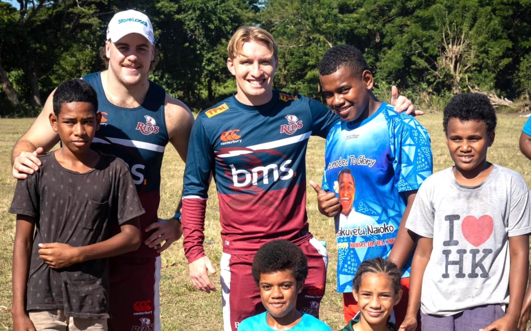 Some young Fijian fans with their Reds players in Nadi on Thursday. The Reds play the Fijian Drua in Suva on Saturday, May 18, 2024. Photo: Reds