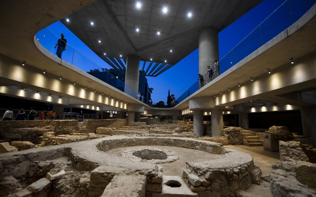 People visit a new section housing the remains of an ancient Athens neighbourhood beneath the Acropolis museum in Athens, on its opening day on June 21, 2019, marking the museum's 10-year-anniversary.