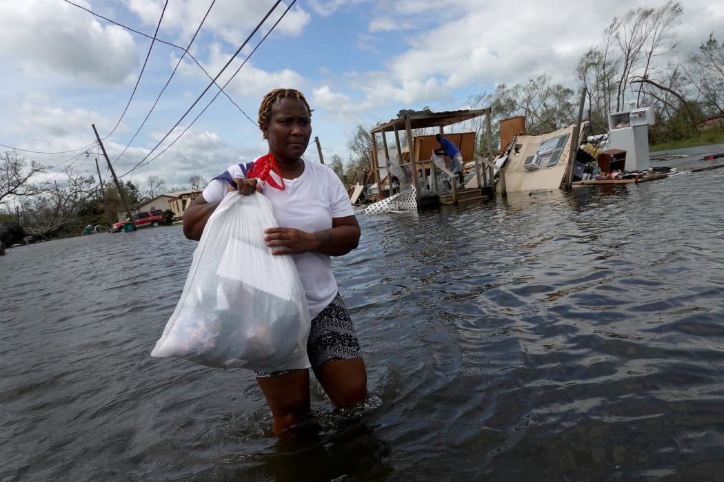 Dina Lewis rescues items from her home in Laplace, Louisiana, which was destroyed by Hurricane Ida on 30 August 2021